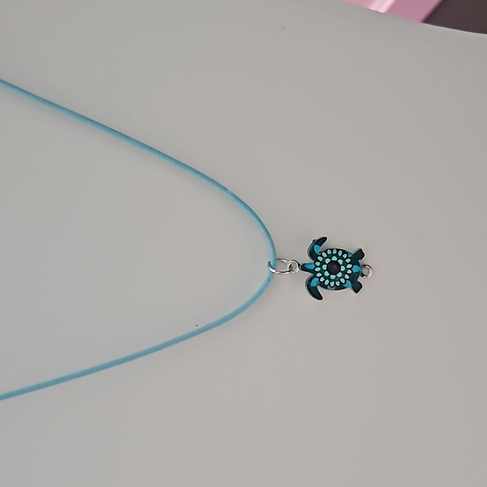 Turtle charm on leather corded necklace